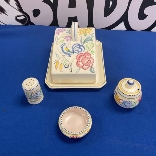 Vintage Poole pottery cheese dish set with floral design.