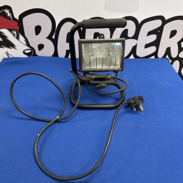 Used halogen site light with three-pin plug for construction or DIY.