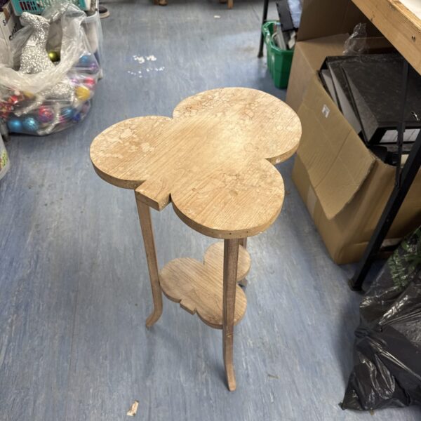 Unique hand of clubs pedestal table with circular top and shelf.