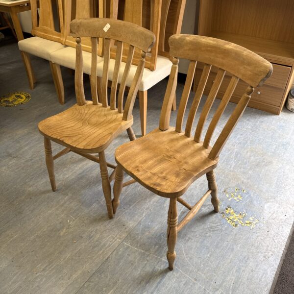 Pair of vintage light oak chairs with spindle backs.