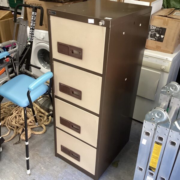 Vintage metal filing cabinet with four drawers for office storage.