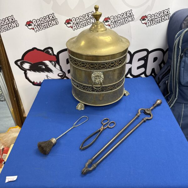 Vintage brass fireside set with lion head coal bucket and tongs.