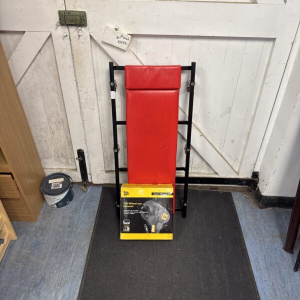 Used mechanics crawler board with JCB 12V impact gun for automotive repairs.
