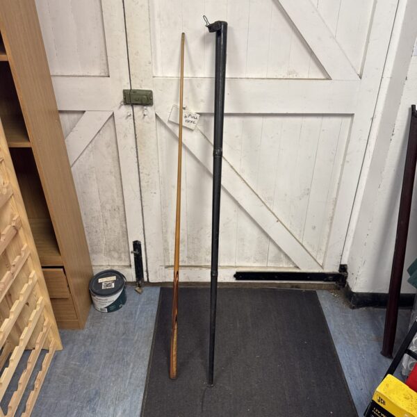 Vintage snooker cue in full view, antique billiards equipment.