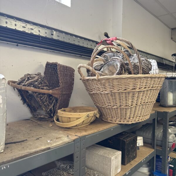 Assorted wicker and hanging baskets for storage and display.