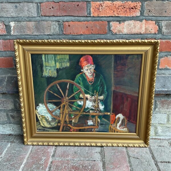 Antique oil painting by R Harland of a woman at a spinning wheel.