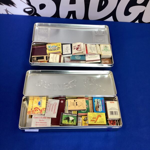 Vintage Camel cigarette tins filled with a diverse matchbook collection.