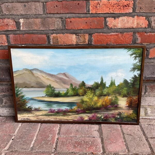 Vintage oil painting of a mountain lake by L w mee.