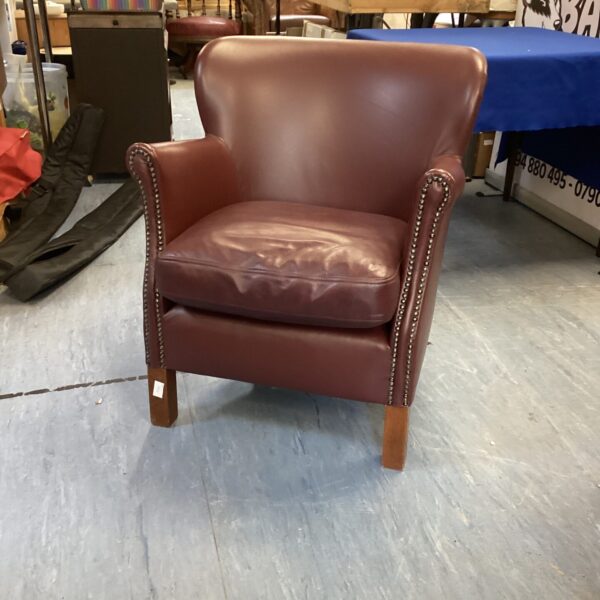 Vintage brown leather professor chair with curved back.