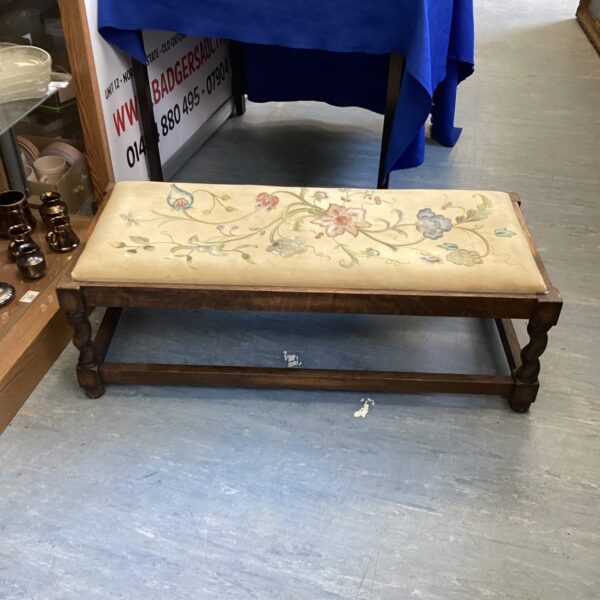 Vintage mahogany foot rest with barley twist legs and floral upholstery.