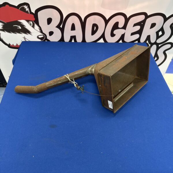 Large vintage metal funnel with gauze insert for kitchen use.