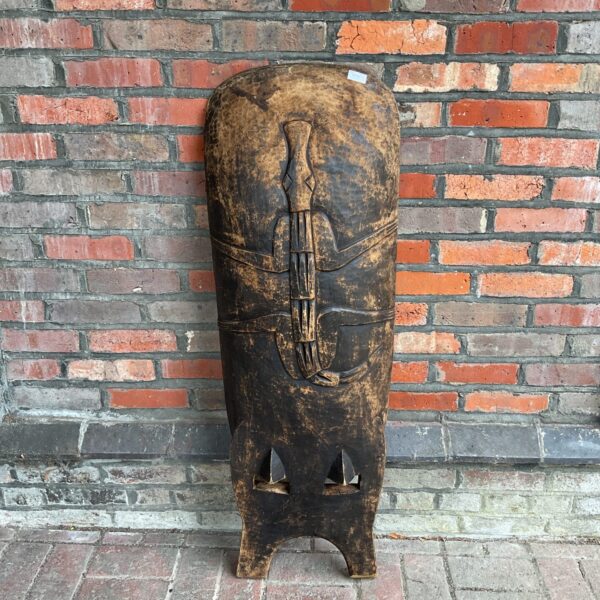 Vintage African carved chair back with stylized face.