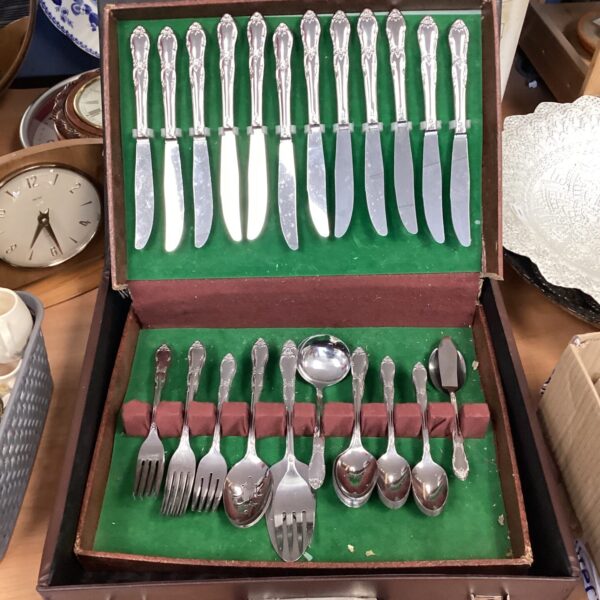Open stainless steel canteen set with vintage cutlery inside.