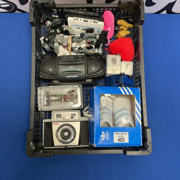 Mixed collectibles lot with Adidas trainers, Kodak camera and vintage toys.
