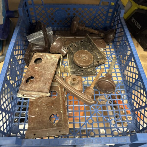 Basket of vintage Bakelite door furniture and antique hardware.