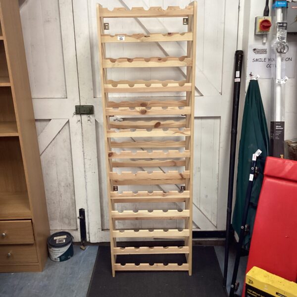 Large wooden wine rack for storing wine bottles.