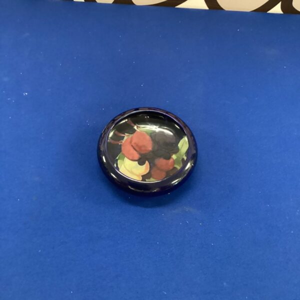 Close-up of a Moorcroft sweet dish with vibrant floral pattern.