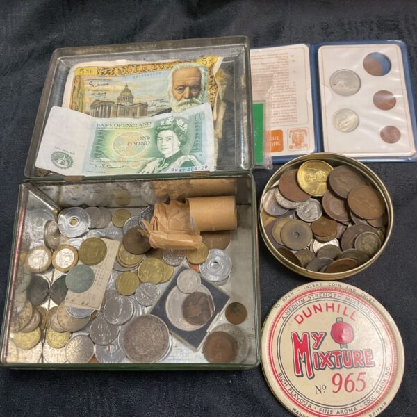 Vintage tin containing a diverse lot of British coins and banknotes.