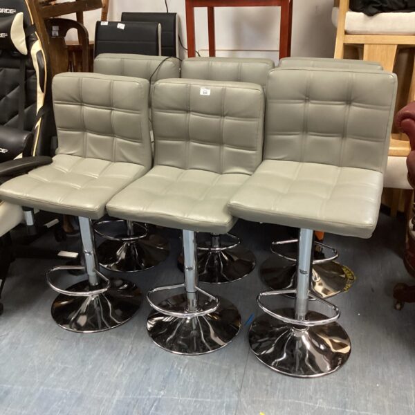 Set of six grey leather bar stools with chrome bases.