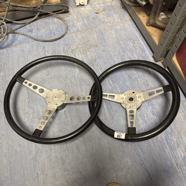 Pair of vintage MG steering wheels for classic car restoration.