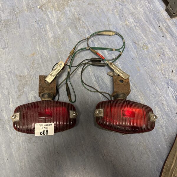 Pair of vintage vehicle rear lights for classic car restoration.