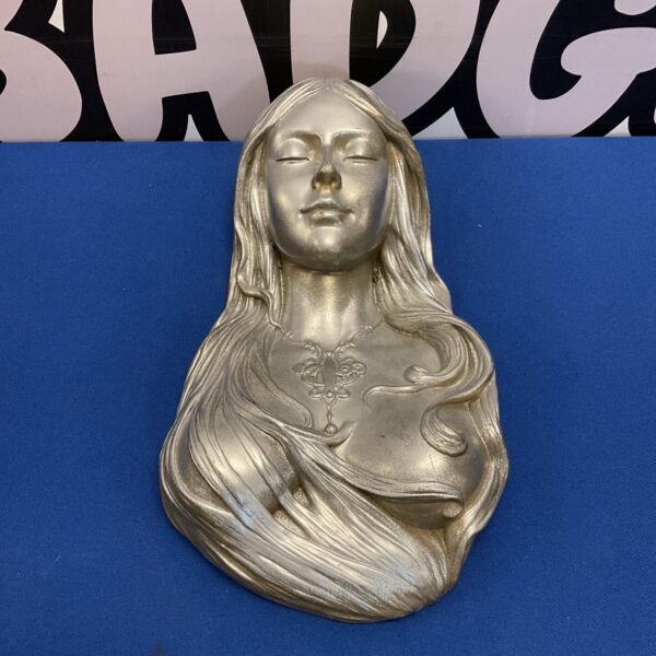 Vintage Art Nouveau wall bust of a peaceful young woman.