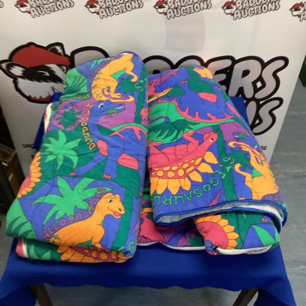 Bright blue dinosaur sleeping bag for children.