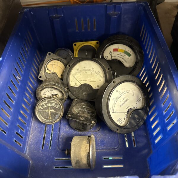 Tray of assorted vintage mechanical gauges for restoration or display.