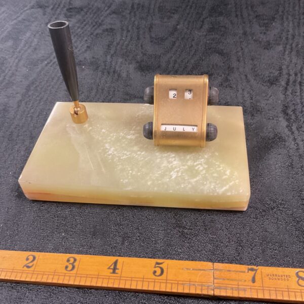 Vintage onyx day date pen holder on a white surface.