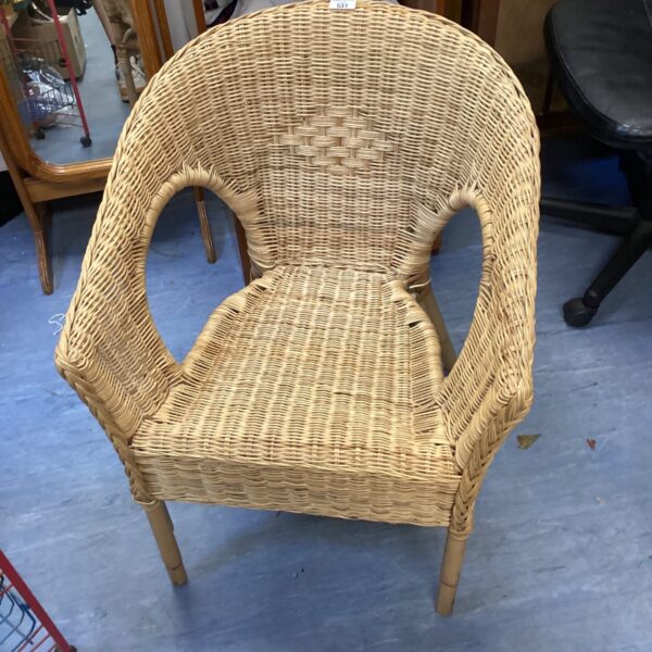 Vintage wicker chair with woven design, perfect for bohemian style.