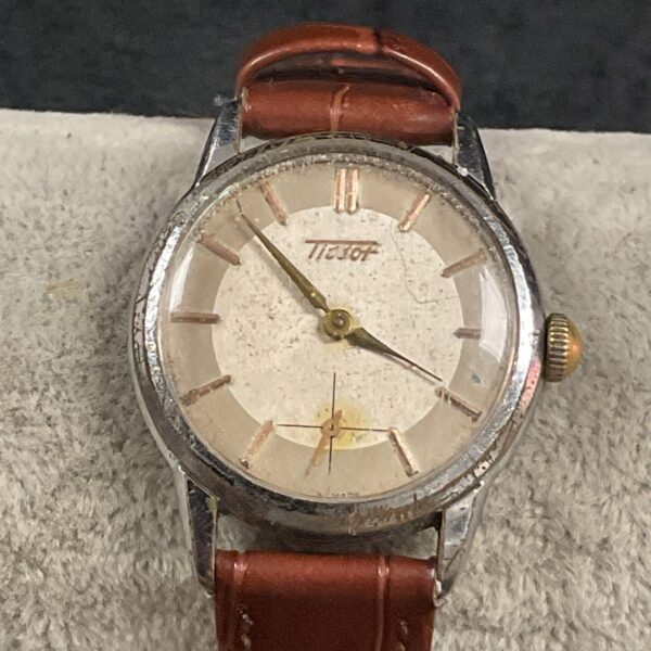 Vintage Tissot wristwatch with silver dial and mechanical movement.