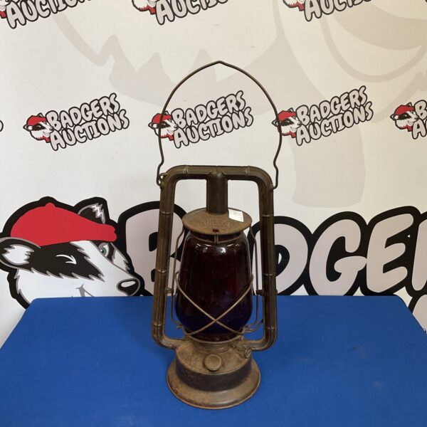 Vintage Dietz hurricane lantern with clear glass globe and metal frame.