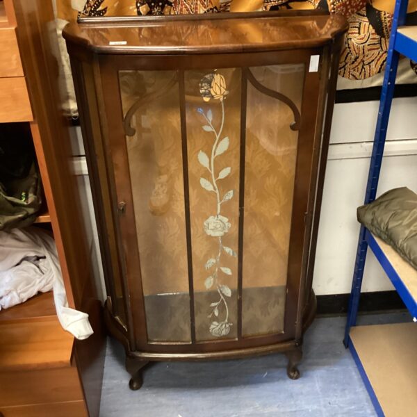 Vintage mahogany display cabinet with curved glass front.