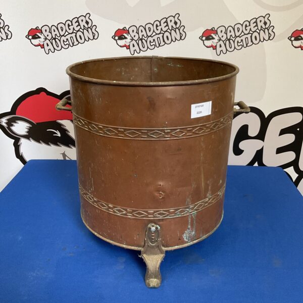 Vintage copper coal bin with ornate detailing and patina.
