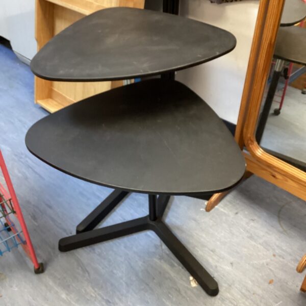 Two adjustable Ikea side tables with circular tops and tripod legs.