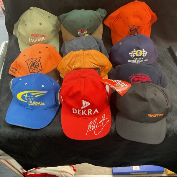 Collection of vintage racing caps and motorsport hats.
