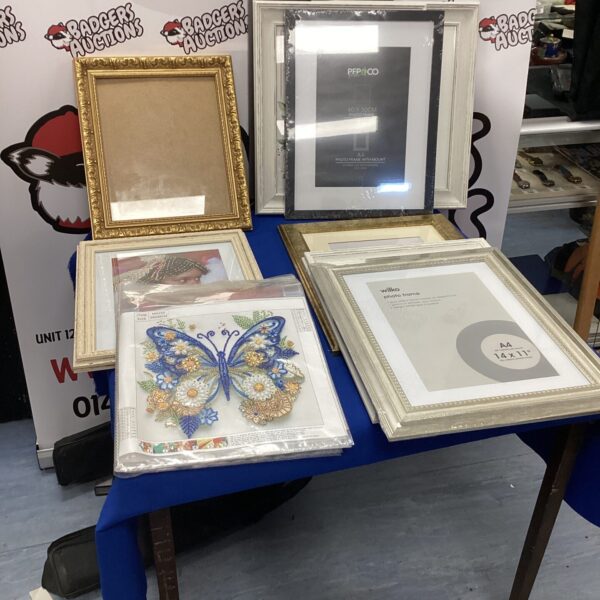 Assorted vintage picture frames and beaded pictures for wall decor.