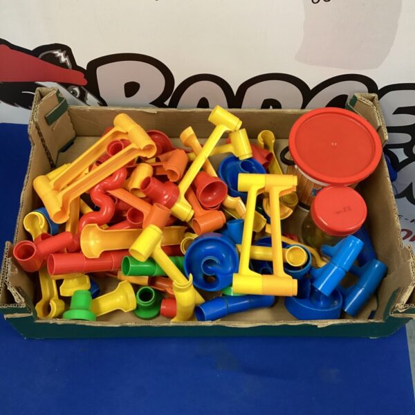 Colourful vintage marble run game set with plastic track pieces.