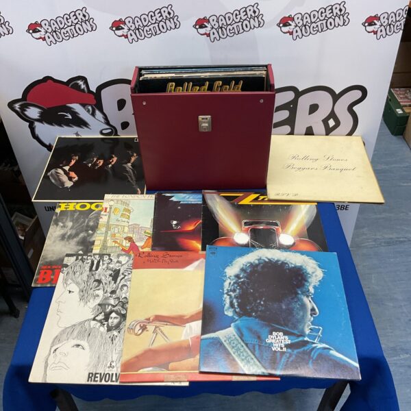Vintage vinyl record lot with ZZ Top and Rolling Stones in carrying case.