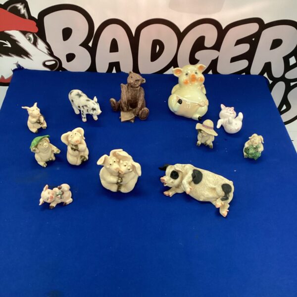 A lot of ceramic pig ornaments for collectors and farmhouse decor.