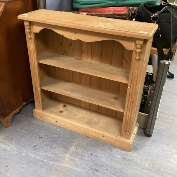 Vintage pine bookcase with shelving for books and decor.