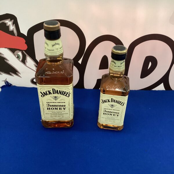 Two bottles of Jack Daniels Honey Whiskey with labels visible.