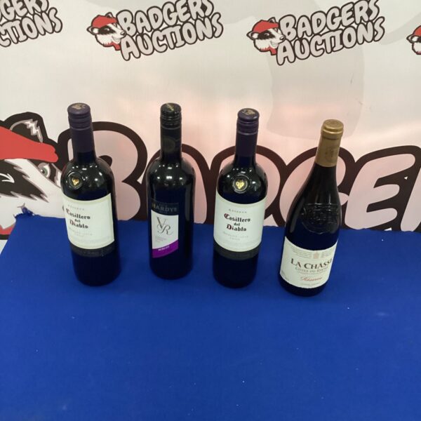 Wine lot featuring a bottle of Hardys Merlot and other red wines.