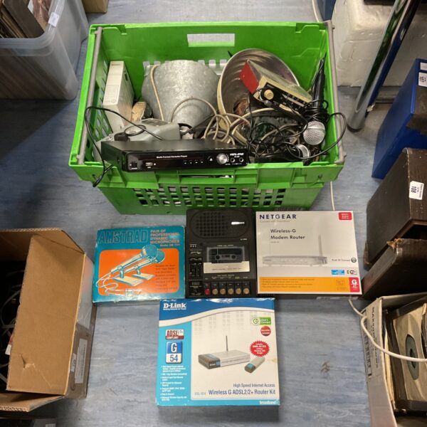 Mixed lot of vintage and modern electrical equipment, including microphones and a router.