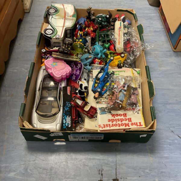 Overview of a mixed toy lot with diecast models and figures.
