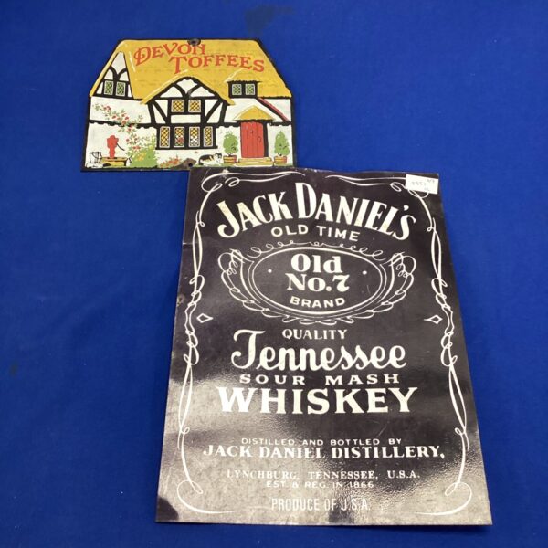Vintage Jack Daniel's and Devon Toffees advertising signs for collectors.