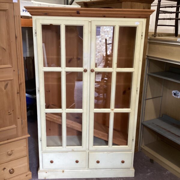 Vintage wooden display cabinet with glazed doors for showcasing collectibles.