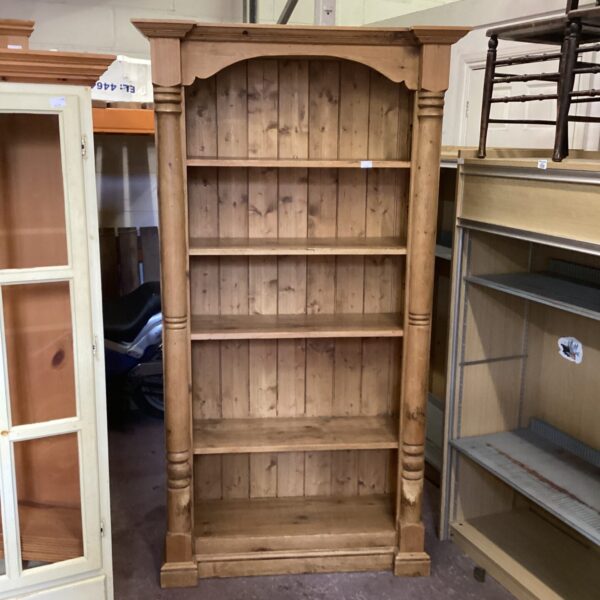Large pine bookcase with a classic country style for storage.