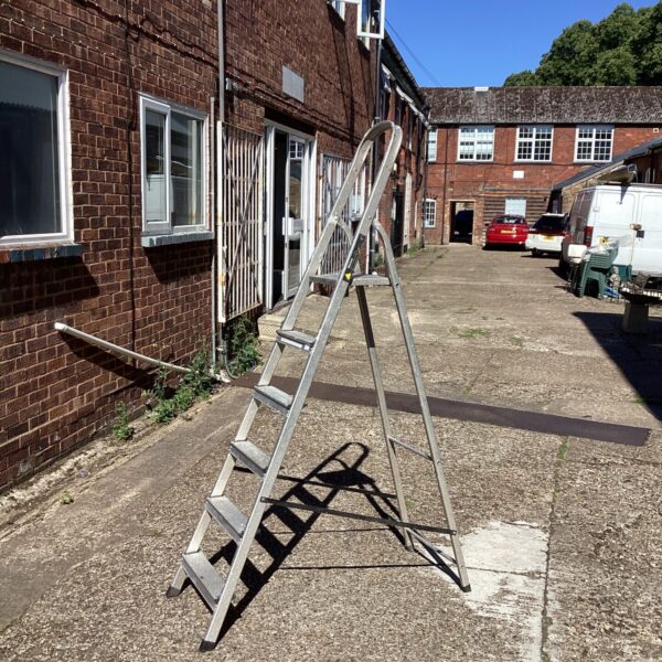 Aluminium step ladder with platform in a residential setting.