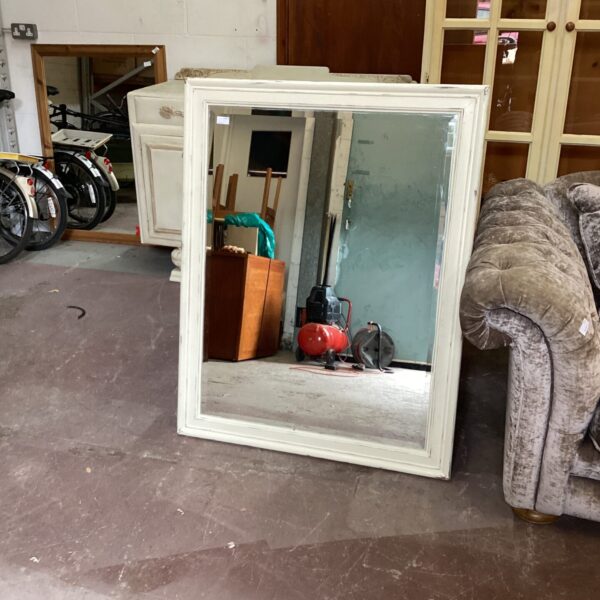 Vintage bevel edge mirror with wooden frame for home decor.